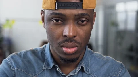 Attractive african man looking to the camera in the office. Stock Footage 108411633
