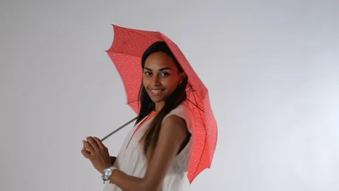 Attractive african model posing with umbrella for a fashion magazine photo shoot Stock Footage 122574305