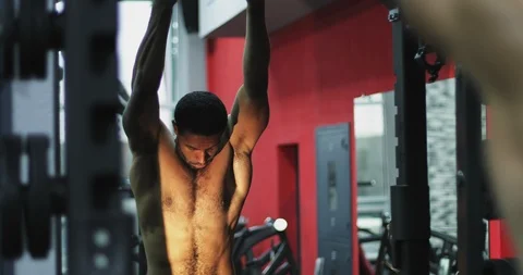 Attractive afro-american man doing stretching in the gym. Stock Footage 101342242