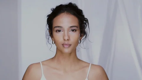 Attractive afro female touching her face and smiling Video stock 123728770