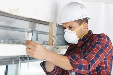 Attractive and confident constructor builder working at construction site Stock Photos