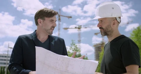 Attractive architect and construction manager discussing constructions plans  Stock Footage 78158345