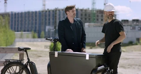 Attractive Architect and construction worker discussing building plans Stock Footage