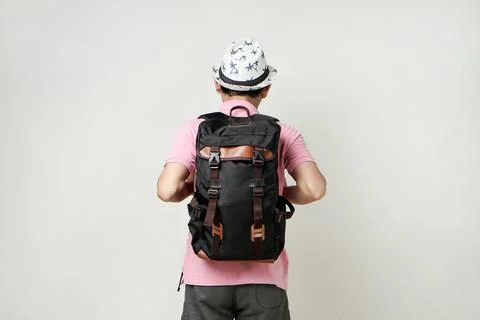 Attractive asian man backpacker back pose portrait. travelling concept. on is Stock Photos