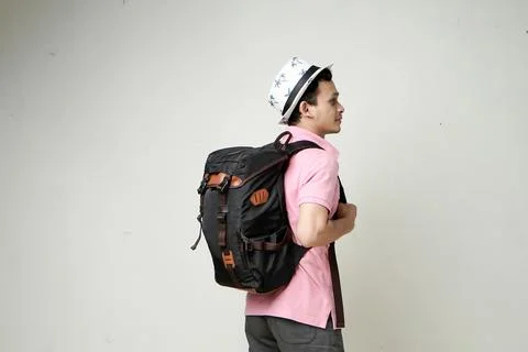 Attractive asian man backpacker back pose portrait. travelling concept. on is Stock Photos