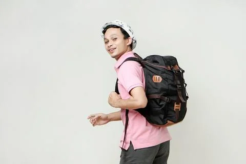 Attractive asian man backpacker backpose with greeting hand palm. travellin.. Stock Photos