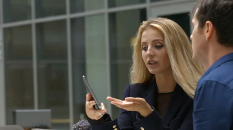 Attractive assistent talking to manager planing using tablet Video stock 64907252