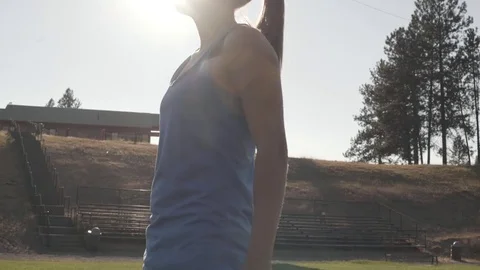 Attractive athlete doing squats on a field Stock Footage 78983503