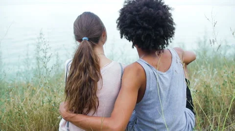 Attractive, athletic black guy hugging his pretty, beautiful girl on the beach Stock Footage 57106321