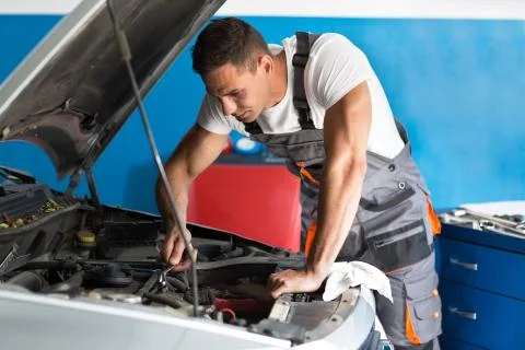 Attractive auto mechanic using a wrench Stock Photos