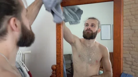 Attractive beard man  Putting together an outfit take off his T-short Video stock 147895348