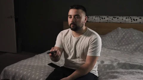 Attractive beard man watching TV at home. Pan medium shot Stock Footage 126111445