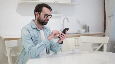 Attractive Beard Young Man using Smartphone Stock Photos