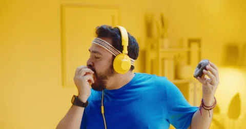 Attractive bearded overweight young man holding and choosing to eat apple than Video stock 165869934