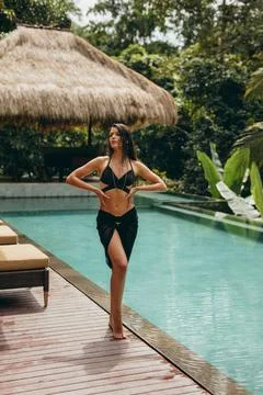 Attractive bikini model posing at poolside Stock-Fotos