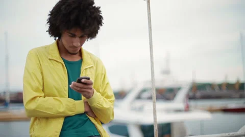 Attractive, black guy uses a smartphone Stock Footage 38337706