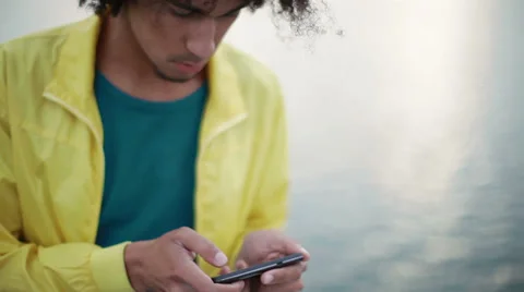 Attractive, black guy uses a smartphone Stock Footage 38337897