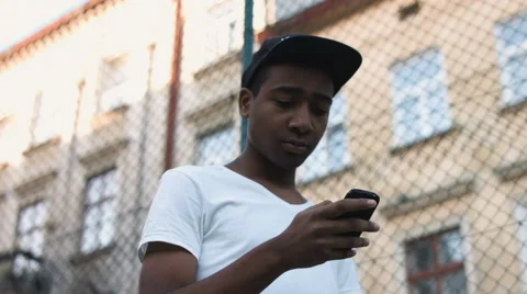 Attractive, black guy uses a smartphone Stock Footage 68509187