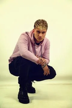 Attractive blond young man in studio shot Stock Photos