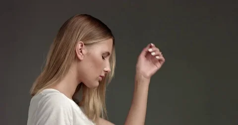 Attractive blond young woman in white top Stock Footage