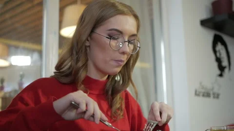 Attractive blonde eats at a cafe a salad with chicken in a cafe. Stock Footage 103689904