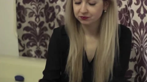 Attractive blonde eats sushi at home Stock Footage 64360037