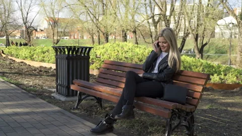 Attractive blonde is talking on the phone Stock Footage 91071887