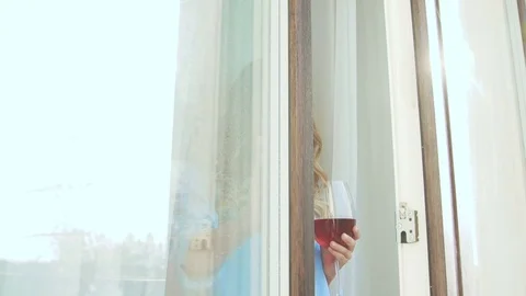 Attractive blonde on terrace with glass of wine. Romantic girl Stock Footage