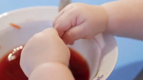 An attractive boy 2 years old climbed into the soup with his hands and touched Stock Footage 73967431