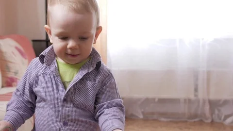 An attractive boy 2 years running around at home and playing with a toy Stock Footage 73844405