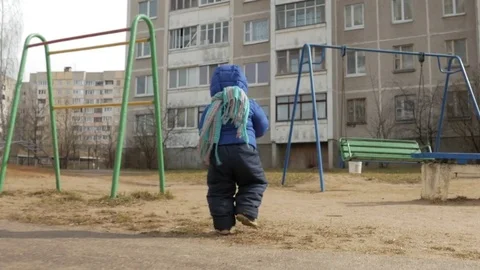 An attractive boy has been walking with his mother for 2 years in the playground Stock Footage 73834607