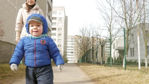 An attractive boy has been walking with his mother for 2 years in the playground Stock Footage 73835430