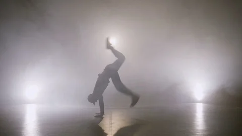 Attractive boy performing breakdance dancing tricks on the stage while auditi Video stock 88631014