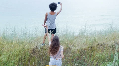 Attractive boy takes selfie on the background of his girlfriend, and tent Video stock 57106001