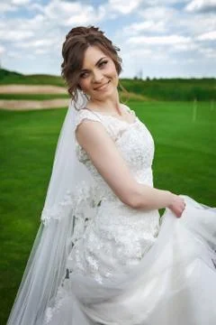 Attractive bride dancing on a meadow Stock Photos