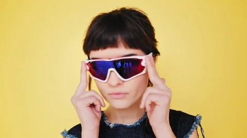 Attractive brunette eats macarons isolated on bright backgrounds Video stock 73296478