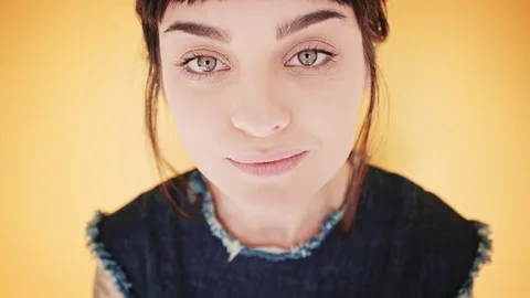 Attractive brunette eats macarons isolated on bright backgrounds Stock Footage 73296622