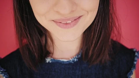 Attractive brunette eats macarons isolated on bright backgrounds Video stock 73298878