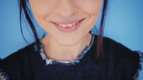 Attractive brunette eats macarons isolated on bright backgrounds Stock-Footage 73299787