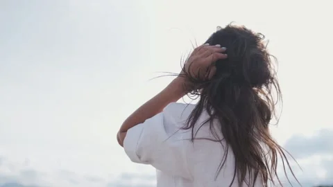 Attractive brunette in a hat and white shirt is enjoying nature in the mountains Видео 131280681