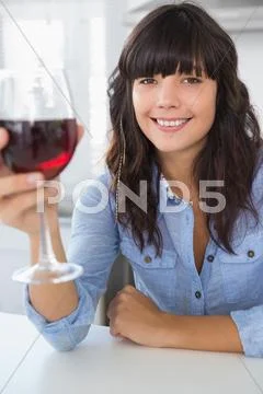 Attractive brunette having glass of red wine Stock Photos