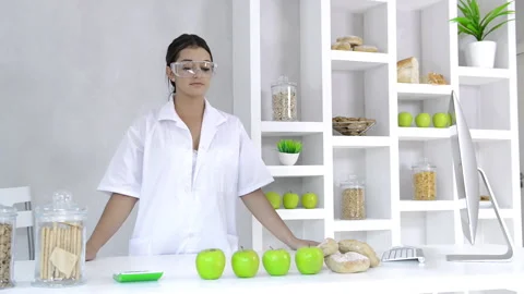 Attractive brunette lab technician working with technology in the study of nutri Vídeos de archivo 199629270