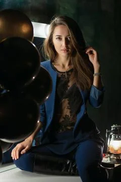 Attractive brunette posing while sitting Stock Photos