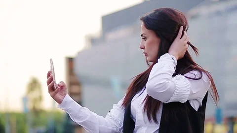 Attractive brunette taking selfies Stock Footage 76980091