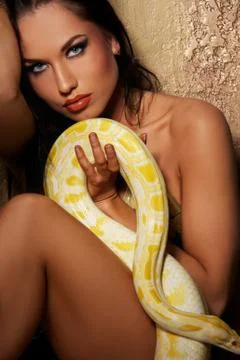 Attractive brunette woman with python Stock Photos