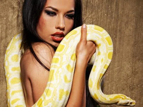 Attractive brunette woman with python 写真素材