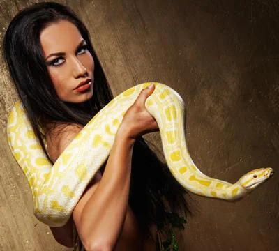 Attractive brunette woman with python Fotos de archivo