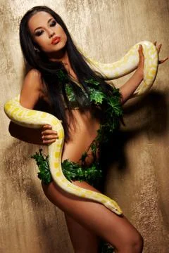 Attractive brunette woman with python Stock Photos