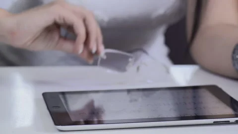 Attractive brunette woman using tablet computer retail internet surfing. Видео 199629085