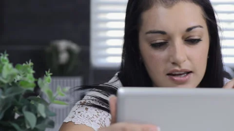 Attractive brunette woman using tablet computer retail internet surfing. Видео 199629167